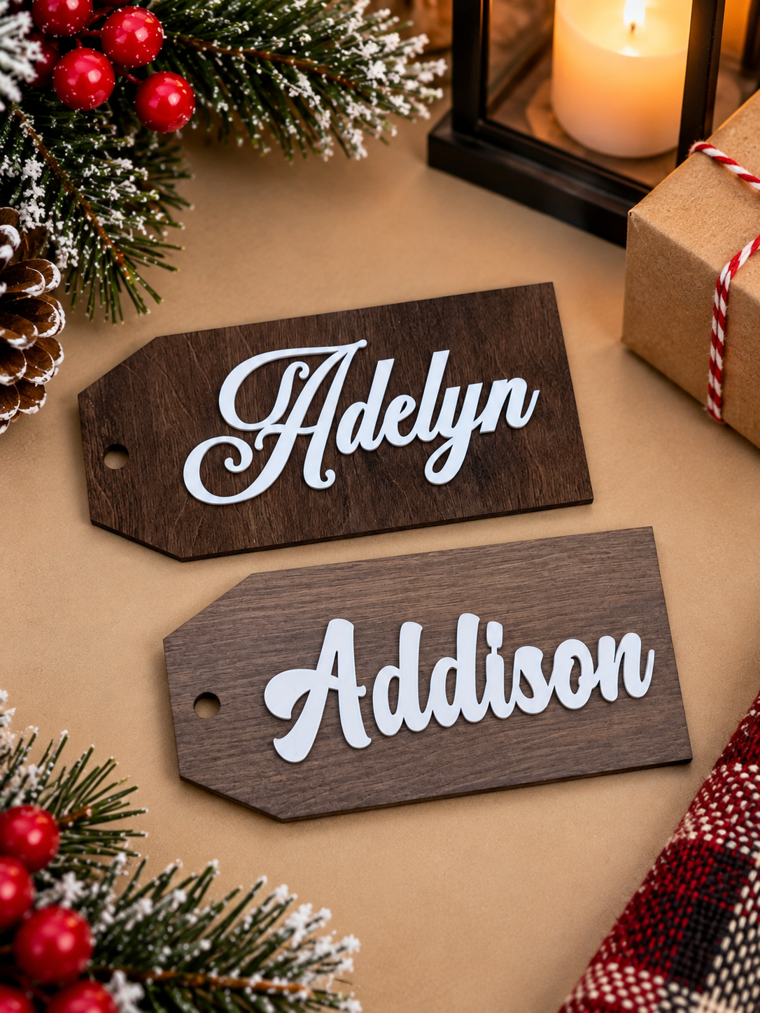 Two dark walnut stocking tags personalized with the names Adelyn and Addison in white script