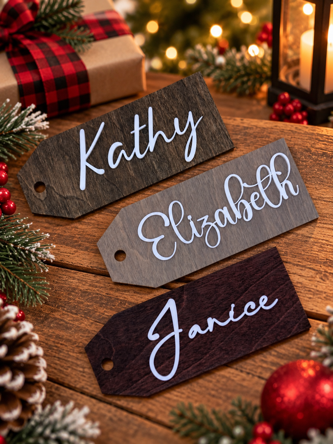 Three personalized wood gift tags in different stain colors with white script names