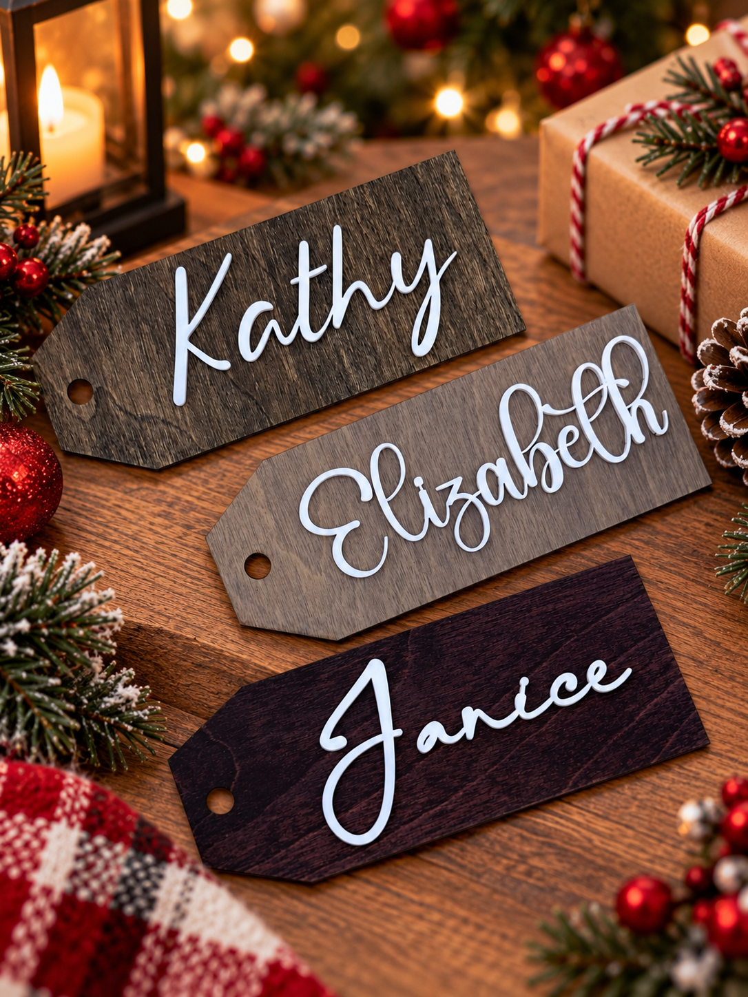 Three stained wood personalized name tags reading Kathy, Elizabeth and Janice in white script